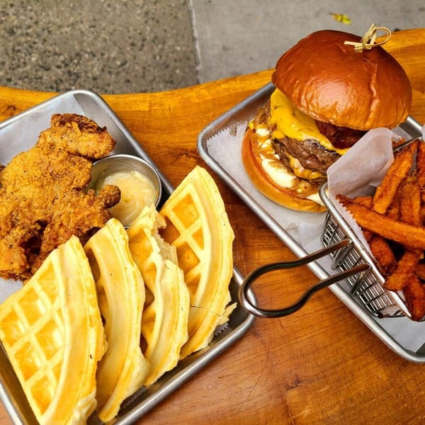 Sin City Burger's fried chicken and waffles with dipping sauce, and a cheeseburger with fries.